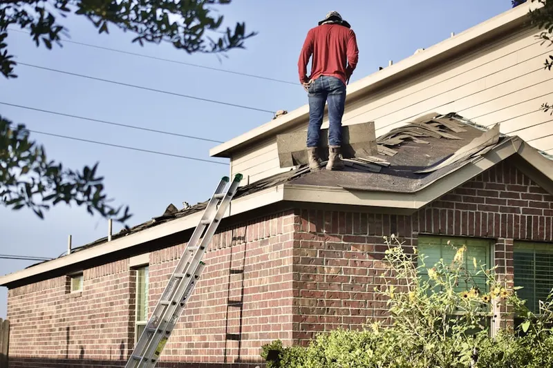 Professional roofer working on a residential roof in La Grange